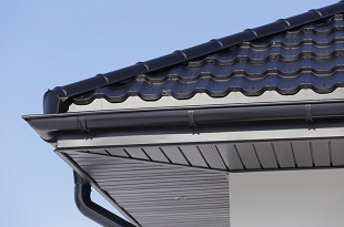 Corner of the new modern house with gutter roof and wall.